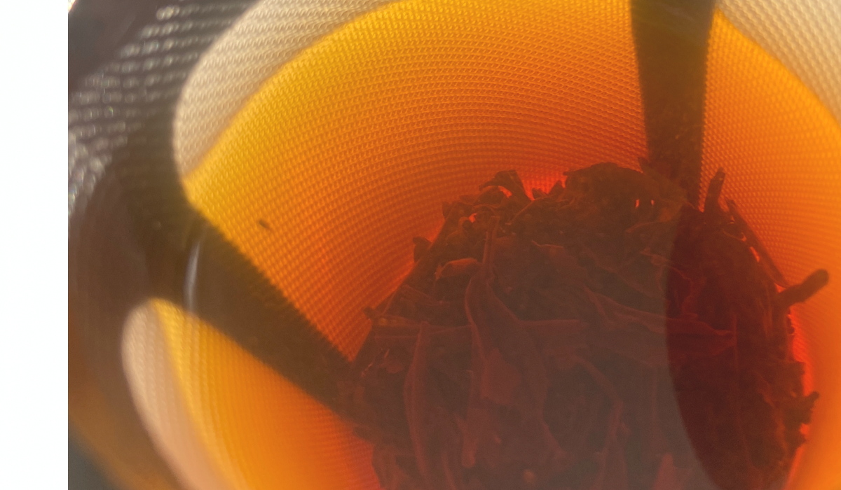 dark red tea in a filter cup